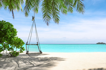 View of beach with swings at tropical resort