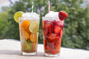  Cold Mojito cocktails drinks lemonade macro close-up with lime, cumquats, strawberry, mint and ice  