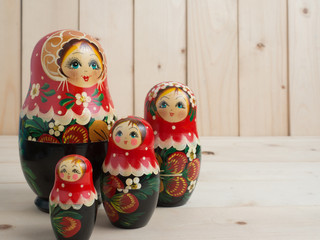 Travel around the world for your colorful life .Enjoy the funny trip journey .Top view for copy space some idea your create destination .object  cute  ,  Set of russain dolls on pine wood  background.