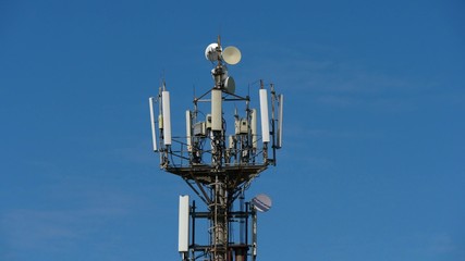 telecommunication cellular tower against blue sky