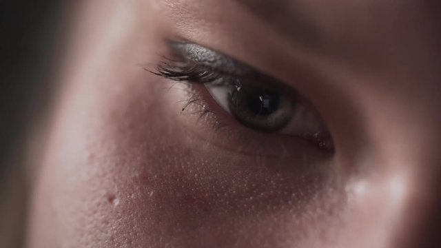 handheld closeup shot of teen girl eyes looking at smartphone screen in sunset light near window