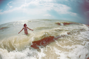 Woman bathing in the ocean.