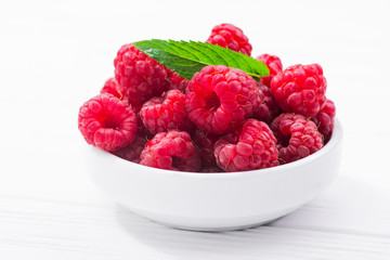 Red fresh raspberry in bowl