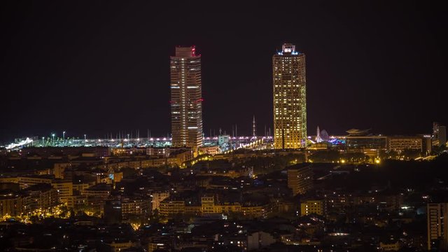 timelpase of the barcelona city skyline throughout the night.