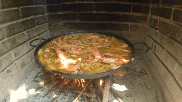 Famous typical spanish rice dish. Spanish paella. Everyday cooking with natural fire. 4k shoot