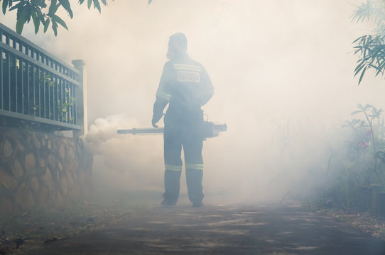 PUTRAJAYA, MALAYSIA - JULY 29, 2017 : Unidentified pest control operator from Ministry Of Helath Malaysia fogging to eliminate mosquito for preventing spread dengue fever and zika virus.