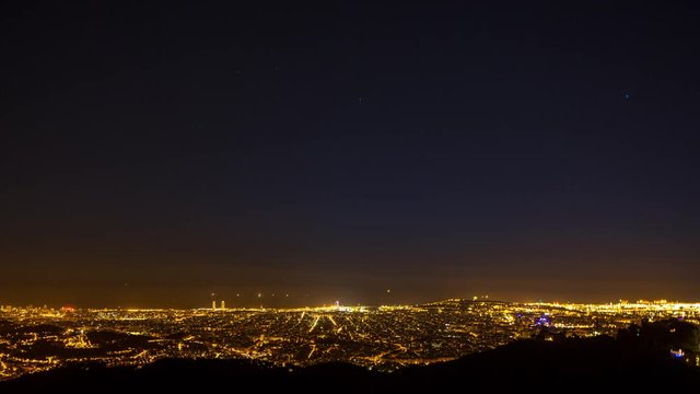 timelapse of the barcelona city skyline throughout the night.