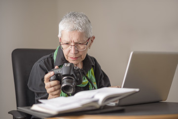 Senior business woman can't figure out how to use a camera