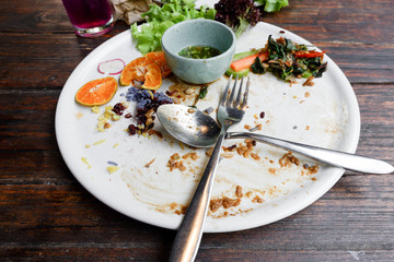 Dirty dish with food scraps and sauce after eat Thai food
