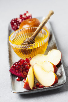 Rosh hashanah (jewish holiday) concept: honey, apple and pomegranate