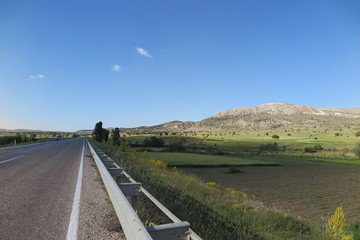 View of highway and green grass field