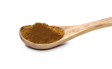 Turmeric (Curcuma) powder pile in wooden spoon isolated on white background