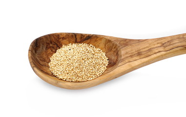 Organic quinoa seeds in wooden spoon isolated on white background, top, view