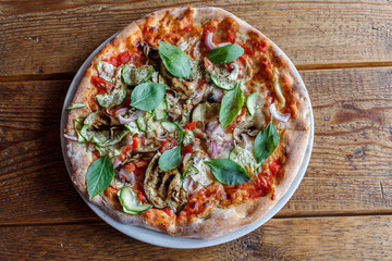 Vegetarian pizza on a white plate in a restaurant