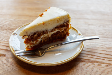 Carrot cake piece on a white plate