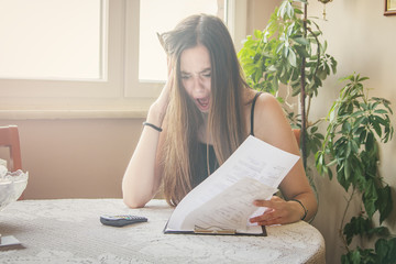 Woman shocked and surprised with her electricity bills