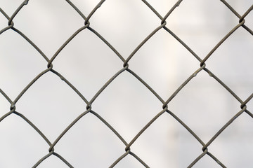 Fence grid close up, blurred background of the grey color