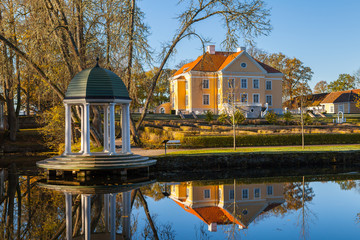 Manor with a pond, and rotunda at sunrise. Palmse, Estonia.