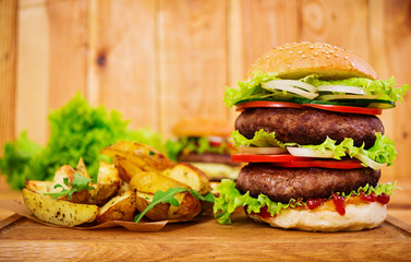 Delicious handmade burger on wooden background. Close view