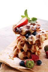 Traditional belgian waffles with fresh fruit and powder sugar