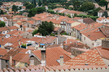 View of traditional and typical small village with red-tiled roofs in south of France