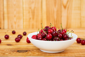 Tasty sweet cherry on wooden background