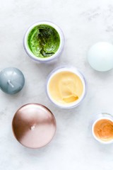 Organic skincare cosmetics on white marble background. Creams, balms, masks, oils, serums. Top view.  Beauty blogger concept