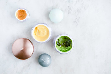 Organic skincare cosmetics on white marble background. Creams, balms, masks, oils, serums. Top view.  Beauty blogger concept