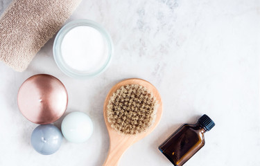 Spa beauty products on white marble table from above. Beauty blogger concept. Copyspace