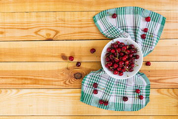 Tasty sweet cherry on wooden background