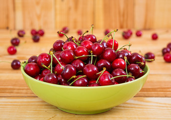 Tasty sweet cherry on wooden background