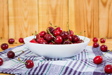 Tasty sweet cherry on wooden background