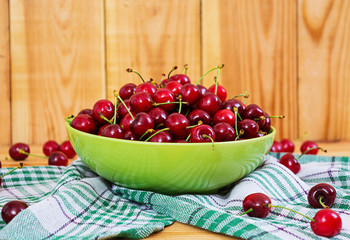 Tasty sweet cherry on wooden background