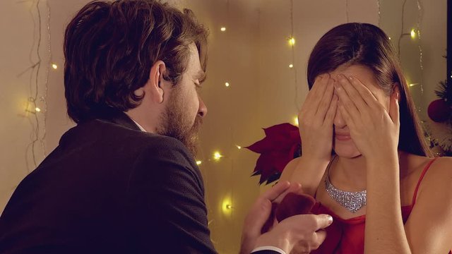 Elegant couple at night man giving proposal ring woman crying for happiness