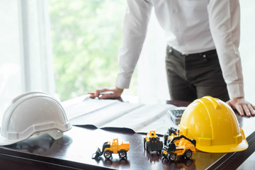 Freelancer - Architect working at home on a design or draft, on his desk
