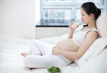 healthy nutrition and pregnancy. pregnant woman's belly and vegetable salad