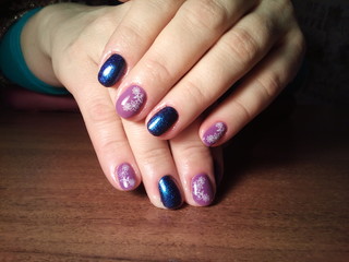 The manicurist excellently made her work a beautiful manicure with a polish gel on her hands and the client is happy