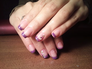 The manicurist excellently made her work a beautiful manicure with a polish gel on her hands and the client is happy