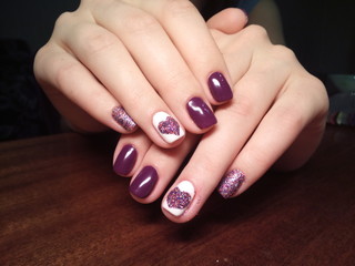 The manicurist excellently made her work a beautiful manicure with a polish gel on her hands and the client is happy