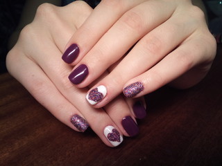 The manicurist excellently made her work a beautiful manicure with a polish gel on her hands and the client is happy