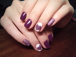 The manicurist excellently made her work a beautiful manicure with a polish gel on her hands and the client is happy