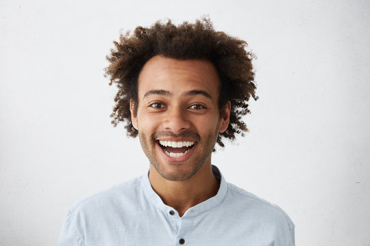 Positive human facial expressions. Stuido portrait of happy cheerful young African American customer or businessman with Afro hairstyle looking at camera in excitement, happy with good news