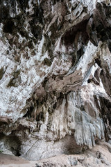 Fototapeta na wymiar Limestone stalactites and stalagmites in Phra Nang cave