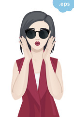 Fashionable young woman wearing sunglasses. A girl is holding her hands in front of her lips with a dodgy kiss.