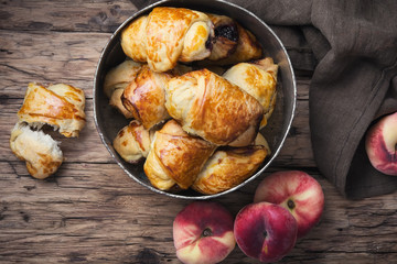 Tasty croissants with peaches
