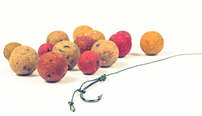 Carp hook boilies on the white background . CloseUp .