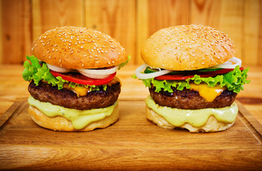 Delicious handmade burger on wooden background. Close view