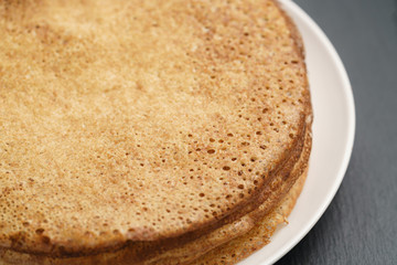 homemade blini stack on plate on slate board