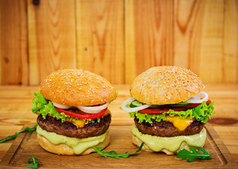 Delicious handmade burger on wooden background. Close view
