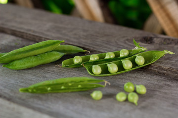 young juicy green peas on a wooden table